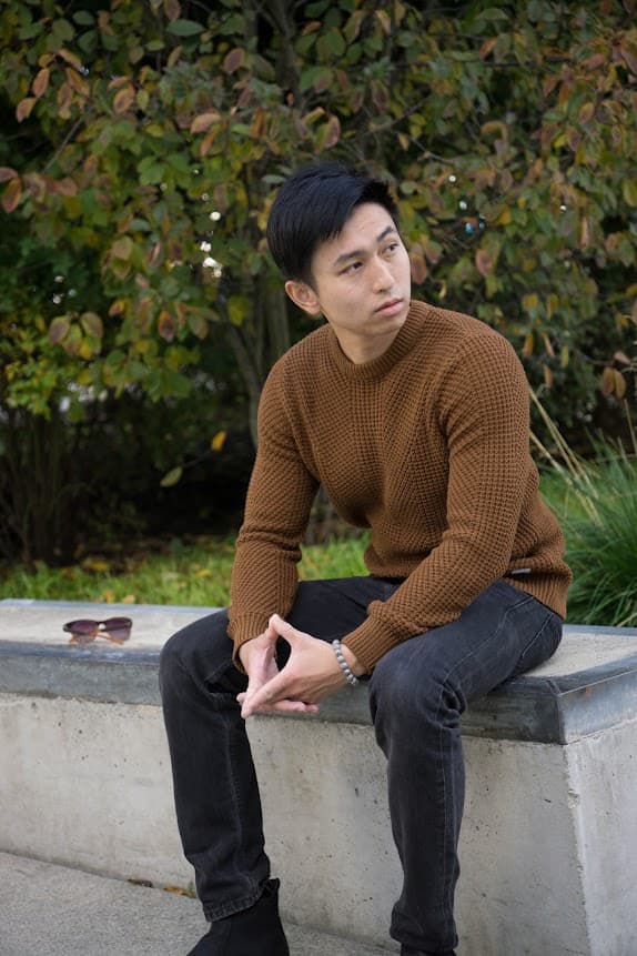 Michael Huang — founder of SI8 Technology, seated outdoors
